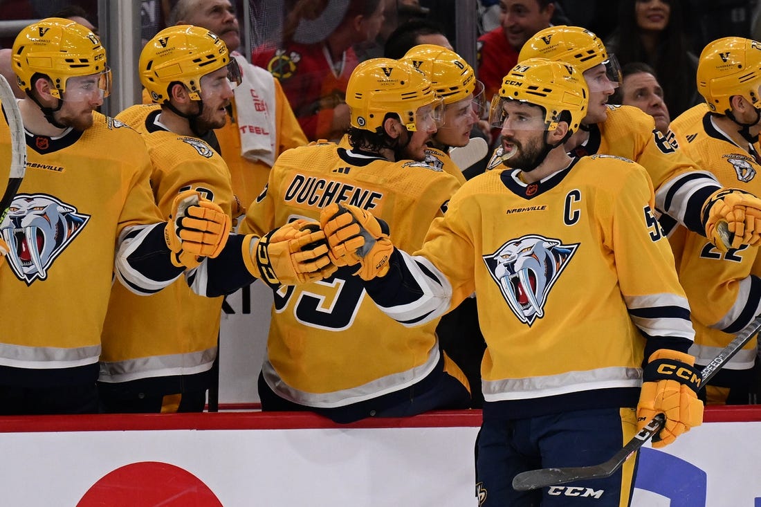 Dec 21, 2022; Chicago, Illinois, USA; Nashville Predators defenseman Roman Josi (59) celebrates at the bench after scoring a goal in the third period against the Chicago Blackhawks at United Center. Nashville defeated Chicago 4-2. Mandatory Credit: Jamie Sabau-USA TODAY Sports