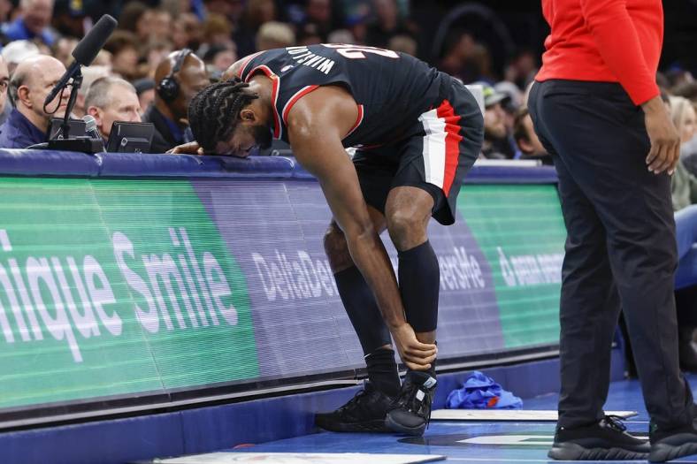 Dec 21, 2022; Oklahoma City, Oklahoma, USA; Portland Trail Blazers forward Justise Winslow (26) grabs his left ankle after a play against the Oklahoma City Thunder during the second half at Paycom Center. Oklahoma City won 101-98. Mandatory Credit: Alonzo Adams-USA TODAY Sports