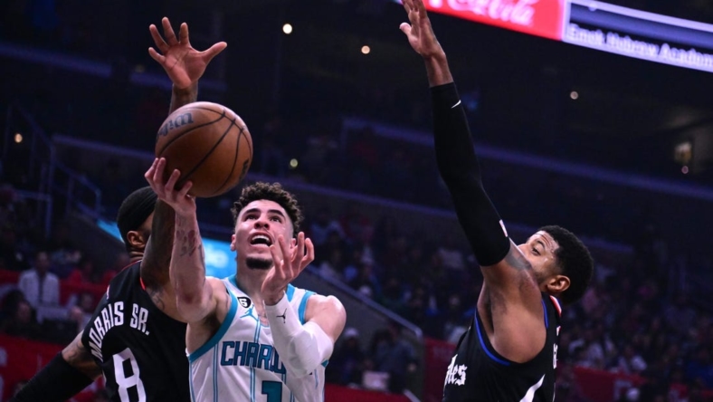 Dec 21, 2022; Los Angeles, California, USA; Charlotte Hornets guard LaMelo Ball (1) goes to the basket past Los Angeles Clippers forward Marcus Morris (8) during the second quarter at Crypto.com Arena. Mandatory Credit: Richard Mackson-USA TODAY Sports