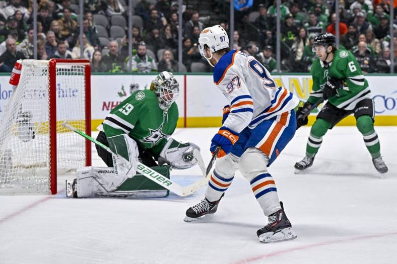 Dec 21, 2022; Dallas, Texas, USA; Edmonton Oilers center Connor McDavid (97) scores a goal against Dallas Stars goaltender Jake Oettinger (29) during the third period at the American Airlines Center. Mandatory Credit: Jerome Miron-USA TODAY Sports