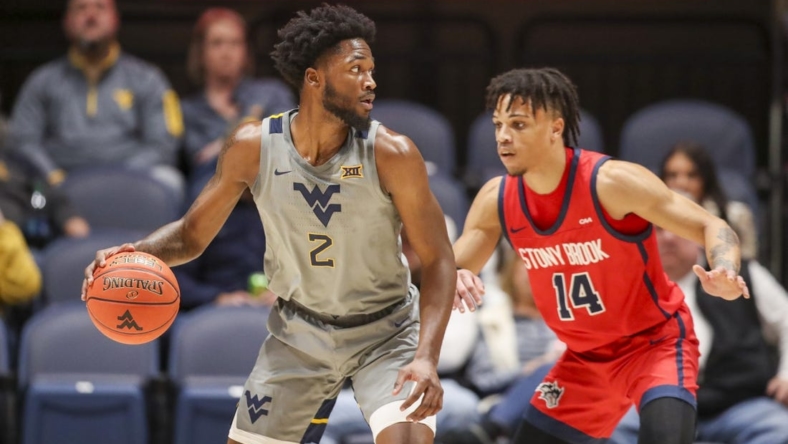 Dec 22, 2022; Morgantown, West Virginia, USA; West Virginia Mountaineers guard Kobe Johnson (2) dribbles against Stony Brook Seawolves guard Tyler Stephenson-Moore (14) during the first half at WVU Coliseum. Mandatory Credit: Ben Queen-USA TODAY Sports