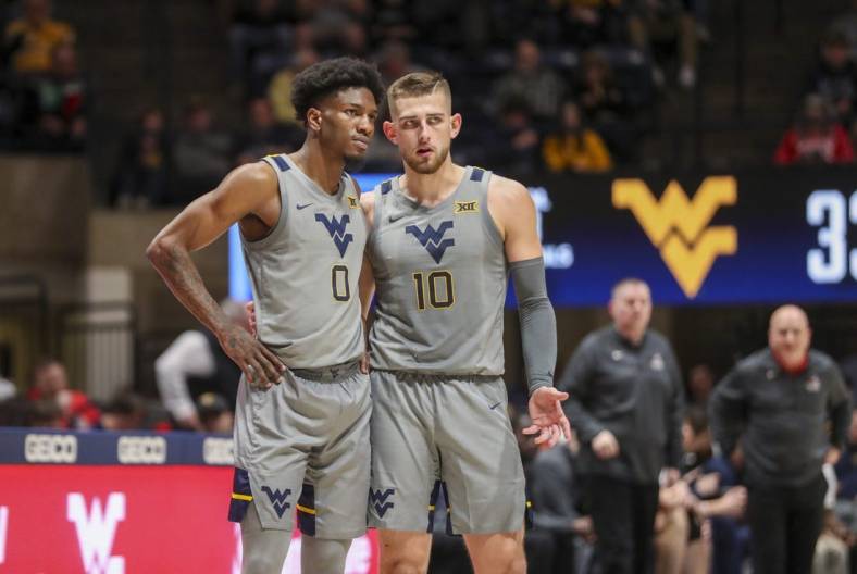 Dec 22, 2022; Morgantown, West Virginia, USA; West Virginia Mountaineers guard Erik Stevenson (10) talks with West Virginia Mountaineers guard Kedrian Johnson (0) during the second half against the Stony Brook Seawolves at WVU Coliseum. Mandatory Credit: Ben Queen-USA TODAY Sports