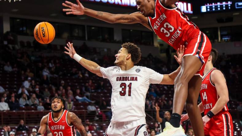 Dec 22, 2022; Columbia, South Carolina, USA; South Carolina Gamecocks forward Benjamin Bosmans-Verdonk (31) and Western Kentucky Hilltoppers center Jamarion Sharp (33) battle for a rebound in the first half at Colonial Life Arena. Mandatory Credit: Jeff Blake-USA TODAY Sports