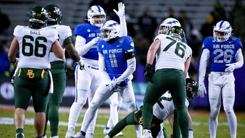 Dec 22, 2022; Fort Worth, TX, USA; Air Force Falcons safety Camby Goff (11) celebrates after tacking Baylor Bears quarterback Blake Shapen (12) for a loss during the first half in the 2022 Armed Forces Bowl at Amon G. Carter Stadium. Mandatory Credit: Jerome Miron-USA TODAY Sports