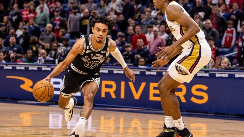 Dec 22, 2022; New Orleans, Louisiana, USA; San Antonio Spurs guard Tre Jones (33) drives to the basket against New Orleans Pelicans forward Herbert Jones (5) during the first half at Smoothie King Center. Mandatory Credit: Stephen Lew-USA TODAY Sports