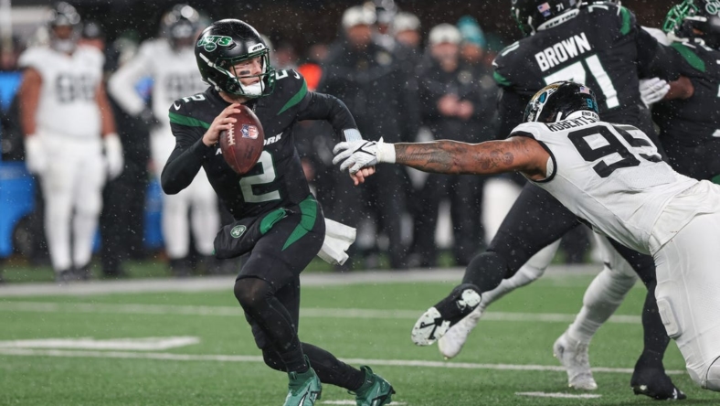 Dec 22, 2022; East Rutherford, New Jersey, USA; New York Jets quarterback Zach Wilson (2) scrambles away from Jacksonville Jaguars defensive end Roy Robertson-Harris (95) during the first half at MetLife Stadium. Mandatory Credit: Vincent Carchietta-USA TODAY Sports