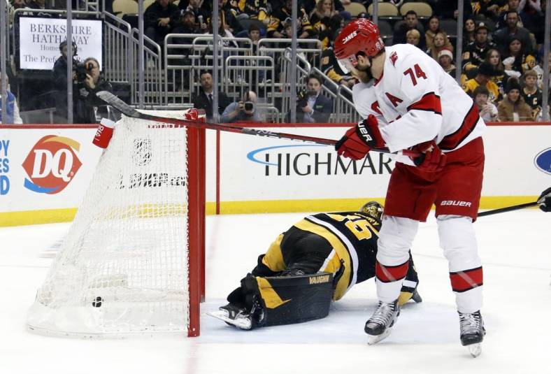 Dec 22, 2022; Pittsburgh, Pennsylvania, USA;  Carolina Hurricanes defenseman Jaccob Slavin (74) scores the game winning goal in overtime against the Pittsburgh Penguins at PPG Paints Arena. Carolina won 4-3 in overtime. Mandatory Credit: Charles LeClaire-USA TODAY Sports