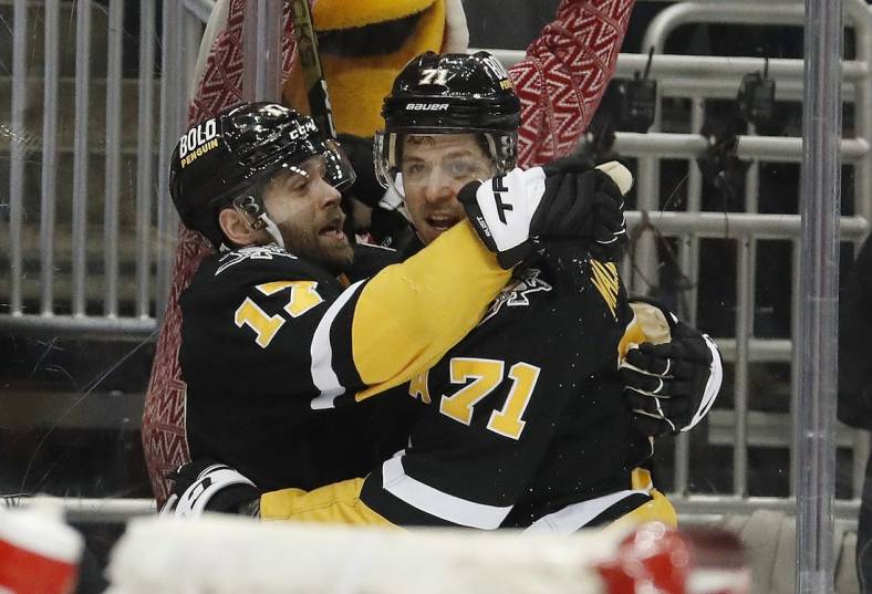 Dec 22, 2022; Pittsburgh, Pennsylvania, USA;  Pittsburgh Penguins right wing Bryan Rust (17) celebrates his goal with center Evgeni Malkin (71) against the Carolina Hurricanes during the third period at PPG Paints Arena. Carolina won 4-3 in overtime. Mandatory Credit: Charles LeClaire-USA TODAY Sports