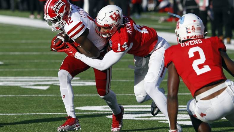 Dec 23, 2022; Shreveport, Louisiana, USA; Louisiana-Lafayette Ragin' Cajuns wide receiver Lance Legendre (12) runs after a catch as Houston Cougars linebacker Mannie Nunnery (14) makes the tackle during the first half in the 2022 Independence Bowl at Independence Stadium. Mandatory Credit: Petre Thomas-USA TODAY Sports