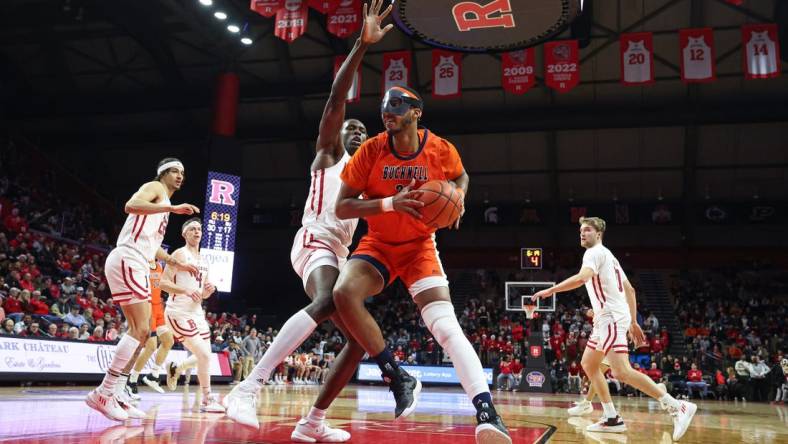 Dec 23, 2022; Piscataway, New Jersey, USA; Bucknell Bison center Andre Screen (23) drives to the basket as Rutgers Scarlet Knights center Clifford Omoruyi (11) defends during the first half at Jersey Mike's Arena. Mandatory Credit: Vincent Carchietta-USA TODAY Sports