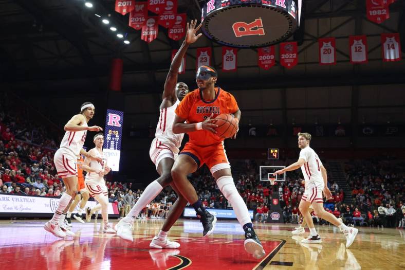 Dec 23, 2022; Piscataway, New Jersey, USA; Bucknell Bison center Andre Screen (23) drives to the basket as Rutgers Scarlet Knights center Clifford Omoruyi (11) defends during the first half at Jersey Mike's Arena. Mandatory Credit: Vincent Carchietta-USA TODAY Sports