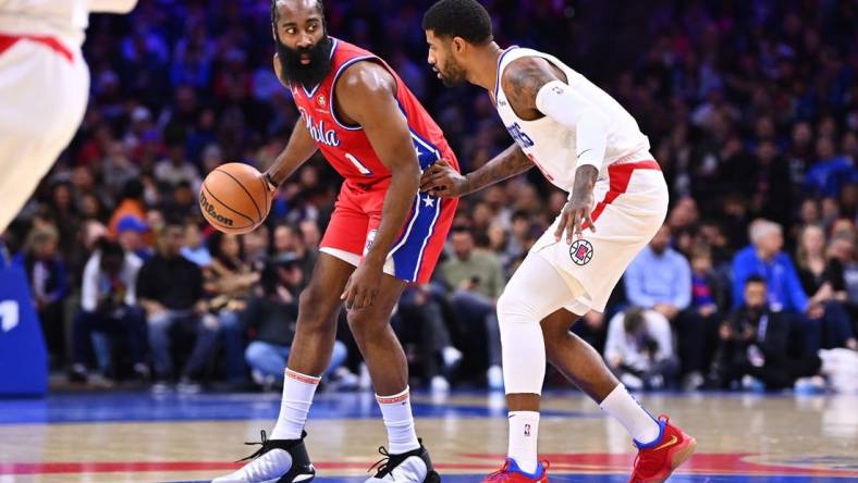Dec 23, 2022; Philadelphia, Pennsylvania, USA; Philadelphia 76ers guard James Harden (1) shields the ball from Los Angeles Clippers forward Paul George (13) in the first quarter at Wells Fargo Center. Mandatory Credit: Kyle Ross-USA TODAY Sports