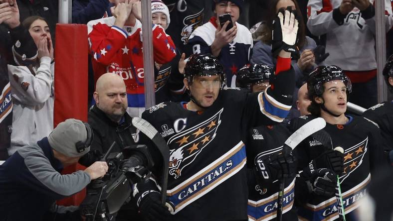 Dec 23, 2022; Washington, District of Columbia, USA; Washington Capitals left wing Alex Ovechkin (8) waves to the crowd from the bench after scoring a goal against the Winnipeg Jets in the first period at Capital One Arena. It was Ovechkin's 801st career goal, moving him into second place all-time in career NHL goals, tying the late Gordie Howe. Mandatory Credit: Geoff Burke-USA TODAY Sports