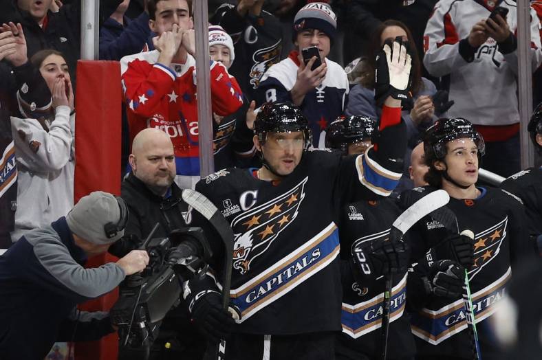 Dec 23, 2022; Washington, District of Columbia, USA; Washington Capitals left wing Alex Ovechkin (8) waves to the crowd from the bench after scoring a goal against the Winnipeg Jets in the first period at Capital One Arena. It was Ovechkin's 801st career goal, moving him into second place all-time in career NHL goals, tying the late Gordie Howe. Mandatory Credit: Geoff Burke-USA TODAY Sports
