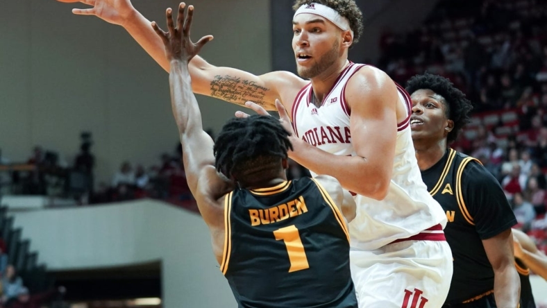 Dec 23, 2022; Bloomington, Indiana, USA;  Indiana Hoosiers forward Race Thompson (25) passes the ball around Kennesaw State Owls guard Terrell Burden (1) during the first half at Simon Skjodt Assembly Hall. Mandatory Credit: Robert Goddin-USA TODAY Sports