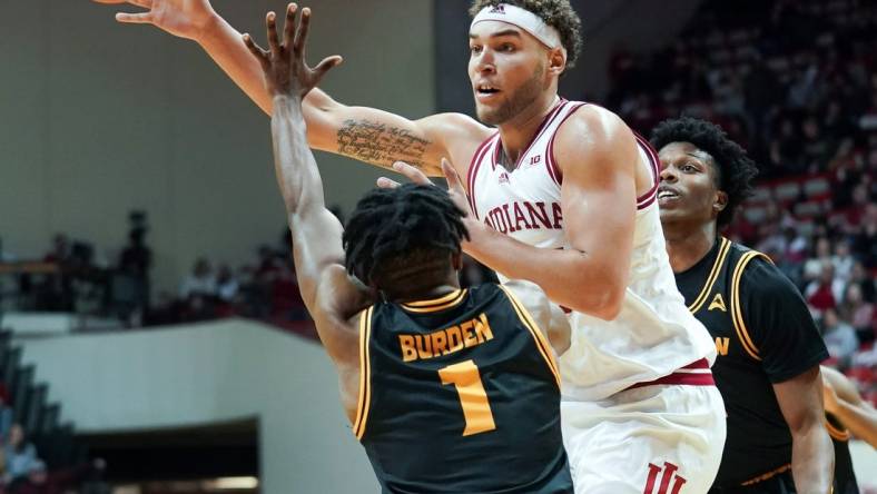 Dec 23, 2022; Bloomington, Indiana, USA;  Indiana Hoosiers forward Race Thompson (25) passes the ball around Kennesaw State Owls guard Terrell Burden (1) during the first half at Simon Skjodt Assembly Hall. Mandatory Credit: Robert Goddin-USA TODAY Sports