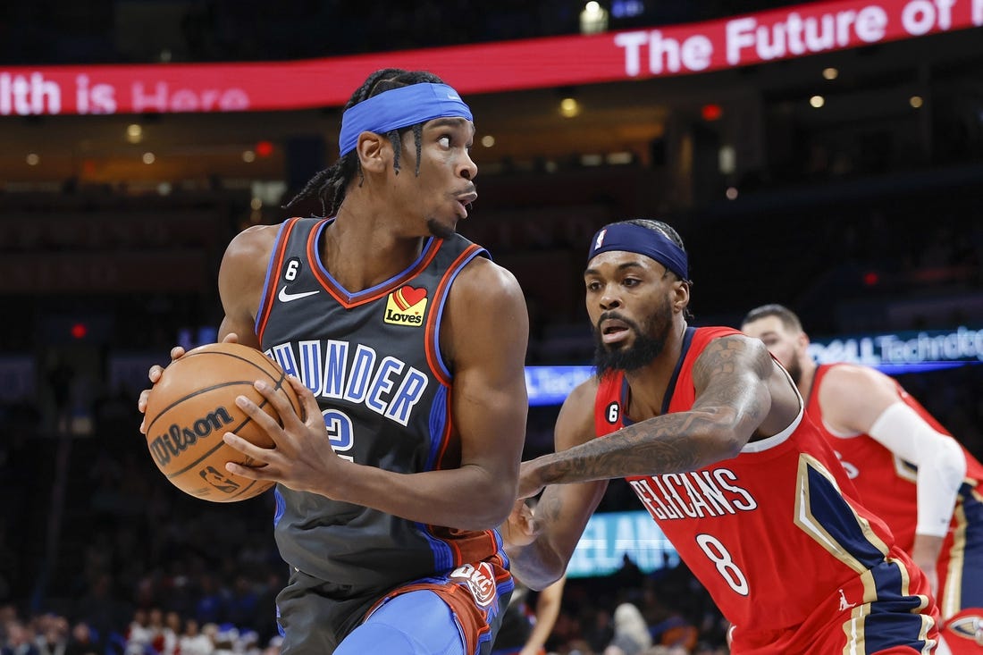 Dec 23, 2022; Oklahoma City, Oklahoma, USA; Oklahoma City Thunder guard Shai Gilgeous-Alexander (2) is defended by New Orleans Pelicans forward Naji Marshall (8) during the first quarter at Paycom Center. Mandatory Credit: Alonzo Adams-USA TODAY Sports