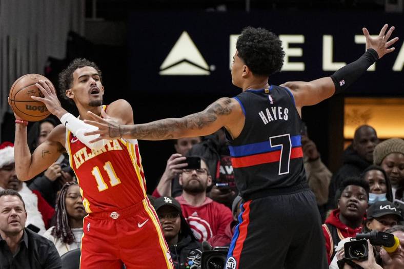 Dec 23, 2022; Atlanta, Georgia, USA; Atlanta Hawks guard Trae Young (11) looks for room to pass against Detroit Pistons guard Killian Hayes (7) during the first half at State Farm Arena. Mandatory Credit: Dale Zanine-USA TODAY Sports