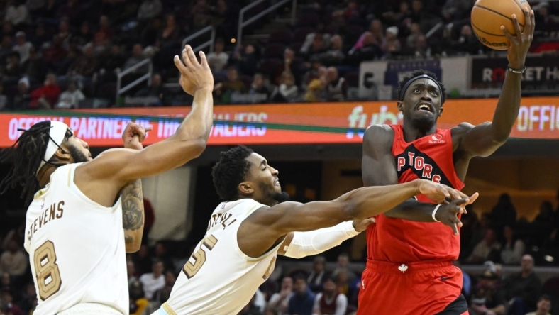 Dec 23, 2022; Cleveland, Ohio, USA; Toronto Raptors forward Pascal Siakam (43) drives to the basket beside Cleveland Cavaliers guard Donovan Mitchell (45) and forward Lamar Stevens (8) in the second quarter at Rocket Mortgage FieldHouse. Mandatory Credit: David Richard-USA TODAY Sports