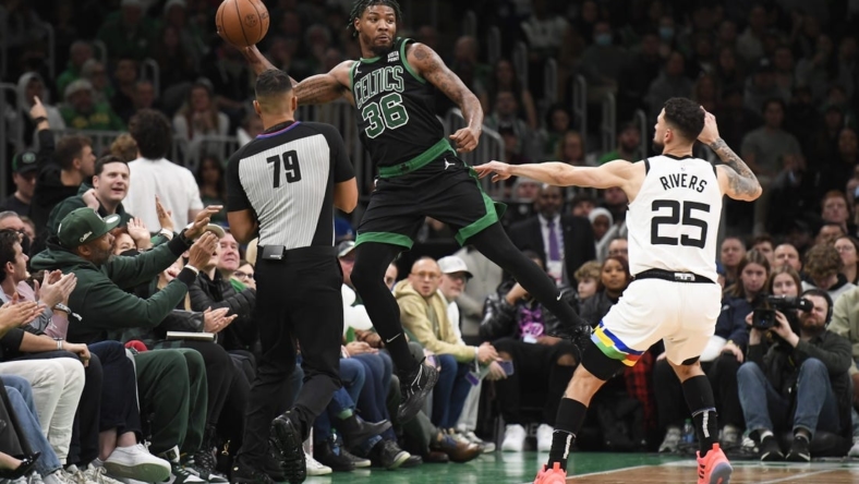 Dec 23, 2022; Boston, Massachusetts, USA;  Boston Celtics guard Marcus Smart (36) saves the ball from going out of bounds while Minnesota Timberwolves guard Austin Rivers (25) defends during the first half at TD Garden. Mandatory Credit: Bob DeChiara-USA TODAY Sports