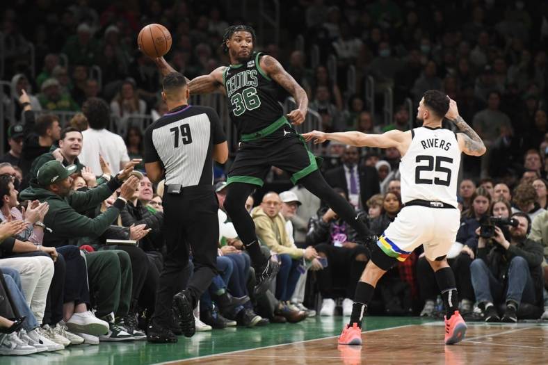 Dec 23, 2022; Boston, Massachusetts, USA;  Boston Celtics guard Marcus Smart (36) saves the ball from going out of bounds while Minnesota Timberwolves guard Austin Rivers (25) defends during the first half at TD Garden. Mandatory Credit: Bob DeChiara-USA TODAY Sports