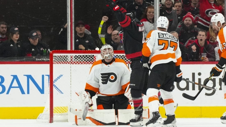 Dec 23, 2022; Raleigh, North Carolina, USA;  Philadelphia Flyers center Morgan Frost (48) celebrates his goal past Philadelphia Flyers goaltender Samuel Ersson (33) during the second period at PNC Arena. Mandatory Credit: James Guillory-USA TODAY Sports