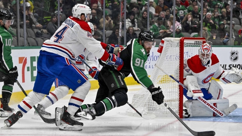 Dec 23, 2022; Dallas, Texas, USA; Montreal Canadiens defenseman Joel Edmundson (44) checks Dallas Stars center Tyler Seguin (91) as goaltender Jake Allen (34) defends the goal during the second period at the American Airlines Center. Mandatory Credit: Jerome Miron-USA TODAY Sports