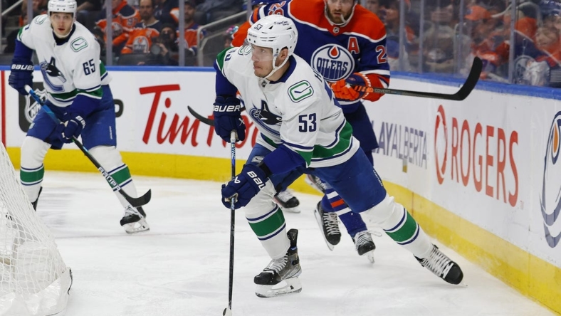 Dec 23, 2022; Edmonton, Alberta, CAN; Vancouver Canucks forward Bo Horvat (53) looks to make a pass in front of Edmonton Oilers forward Leon Draisaitl (29) during the second period at Rogers Place. Mandatory Credit: Perry Nelson-USA TODAY Sports