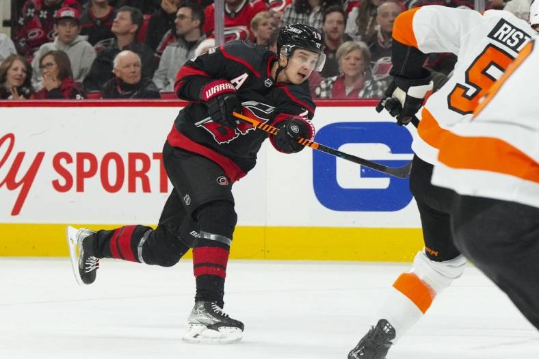 Dec 23, 2022; Raleigh, North Carolina, USA;  Carolina Hurricanes center Sebastian Aho (20) takes a shot against the Philadelphia Flyers during the first period at PNC Arena. Mandatory Credit: James Guillory-USA TODAY Sports