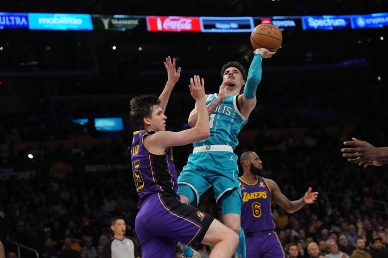 Dec 23, 2022; Los Angeles, California, USA; Charlotte Hornets guard LaMelo Ball (1) shoots the ball against Los Angeles Lakers guard Austin Reaves (15) in the first half at Crypto.com Arena. Mandatory Credit: Kirby Lee-USA TODAY Sports