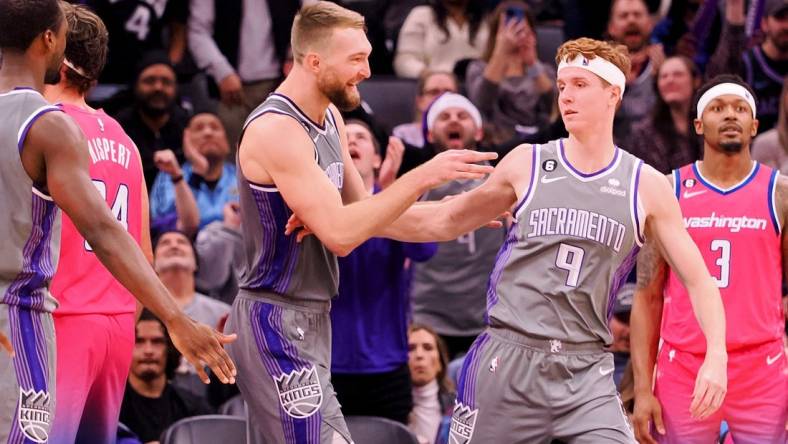 Dec 23, 2022; Sacramento, California, USA; Sacramento Kings power forward Domantas Sabonis (10) celebrates with shooting guard Kevin Huerter (9) after a play against the Washington Wizards during the fourth quarter at Golden 1 Center. Mandatory Credit: Kelley L Cox-USA TODAY Sports