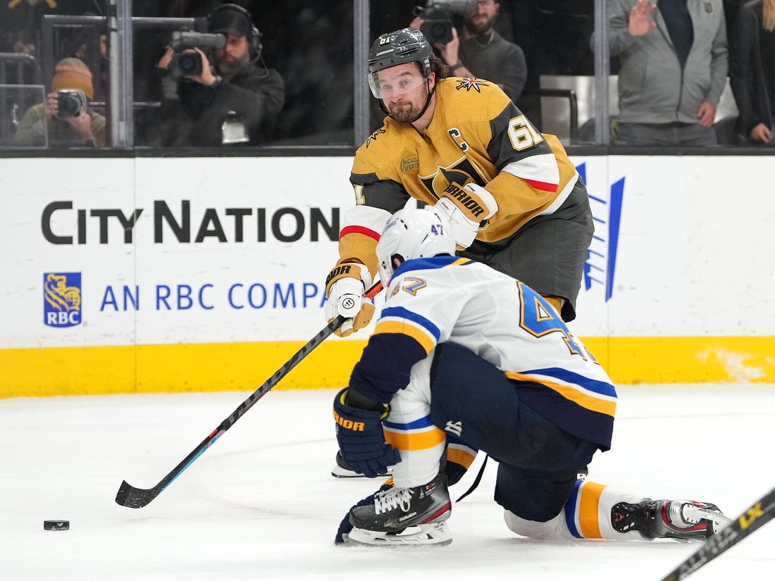 Dec 23, 2022; Las Vegas, Nevada, USA; Vegas Golden Knights right wing Mark Stone (61) sends a pass ahead of St. Louis Blues defenseman Torey Krug (47) during an overtime period at T-Mobile Arena. Mandatory Credit: Stephen R. Sylvanie-USA TODAY Sports