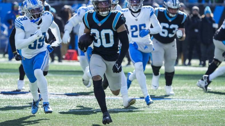 Dec 24, 2022; Charlotte, North Carolina, USA; Carolina Panthers running back Chuba Hubbard (30) runs during the first quarter against the Detroit Lions at Bank of America Stadium. Mandatory Credit: Jim Dedmon-USA TODAY Sports