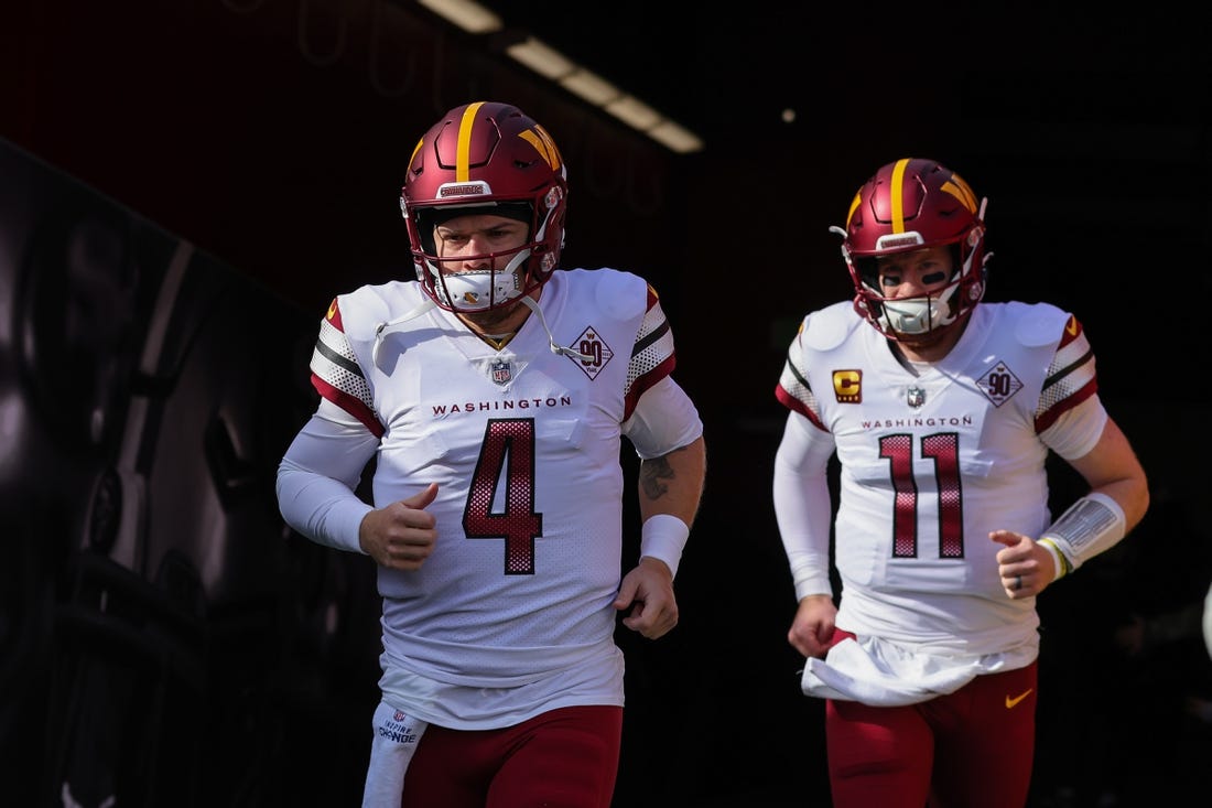 Dec 24, 2022; Santa Clara, California, USA; Washington Commanders quarterback Taylor Heinicke (4) and quarterback Carson Wentz (11) run onto the field before the game against the San Francisco 49ers at Levi's Stadium. Mandatory Credit: Sergio Estrada-USA TODAY Sports