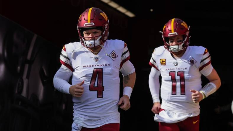 Dec 24, 2022; Santa Clara, California, USA; Washington Commanders quarterback Taylor Heinicke (4) and quarterback Carson Wentz (11) run onto the field before the game against the San Francisco 49ers at Levi's Stadium. Mandatory Credit: Sergio Estrada-USA TODAY Sports