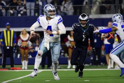 Dec 24, 2022; Arlington, Texas, USA; Dallas Cowboys quarterback Dak Prescott (4) rolls out to avoid the rush by Philadelphia Eagles linebacker Haason Reddick (7) during the second half at AT&T Stadium. Mandatory Credit: Jerome Miron-USA TODAY Sports