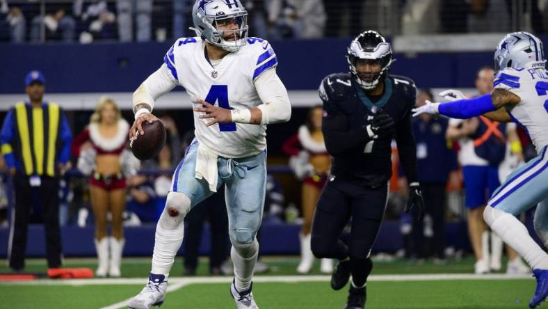 Dec 24, 2022; Arlington, Texas, USA; Dallas Cowboys quarterback Dak Prescott (4) rolls out to avoid the rush by Philadelphia Eagles linebacker Haason Reddick (7) during the second half at AT&T Stadium. Mandatory Credit: Jerome Miron-USA TODAY Sports