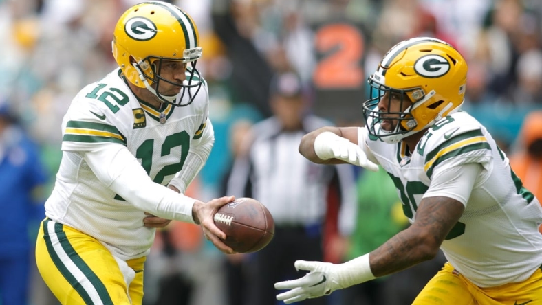 Dec 25, 2022; Miami Gardens, Florida, USA; Green Bay Packers quarterback Aaron Rodgers (12) hands off the football to running back AJ Dillon (28) during the second quarter at Hard Rock Stadium. Mandatory Credit: Sam Navarro-USA TODAY Sports