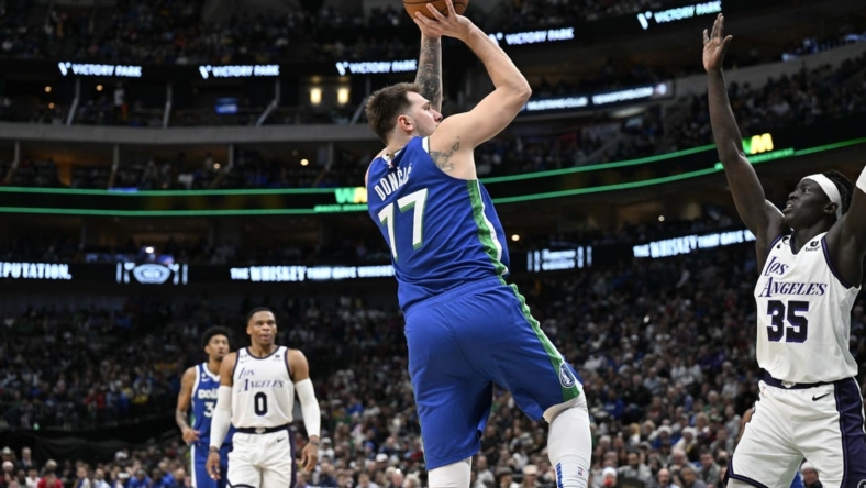 Dec 25, 2022; Dallas, Texas, USA; Dallas Mavericks guard Luka Doncic (77) shoots the ball over Los Angeles Lakers forward Wenyen Gabriel (35) during the second quarter at the American Airlines Center. Mandatory Credit: Jerome Miron-USA TODAY Sports