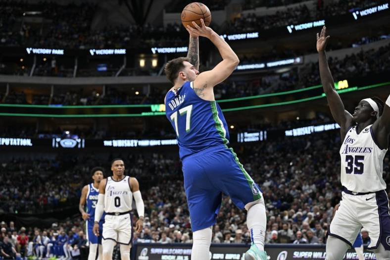 Dec 25, 2022; Dallas, Texas, USA; Dallas Mavericks guard Luka Doncic (77) shoots the ball over Los Angeles Lakers forward Wenyen Gabriel (35) during the second quarter at the American Airlines Center. Mandatory Credit: Jerome Miron-USA TODAY Sports