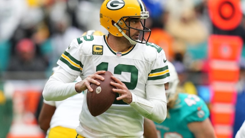 Dec 25, 2022; Miami Gardens, Florida, USA; Green Bay Packers quarterback Aaron Rodgers (12) drops back with the ball before attempting a pass against the Miami Dolphins during the second half at Hard Rock Stadium. Mandatory Credit: Jasen Vinlove-USA TODAY Sports
