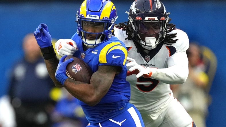Dec 25, 2022; Inglewood, California, USA; Los Angeles Rams running back Cam Akers (3) carries the ball against Denver Broncos linebacker Randy Gregory (5) in the first half at SoFi Stadium. Mandatory Credit: Kirby Lee-USA TODAY Sports