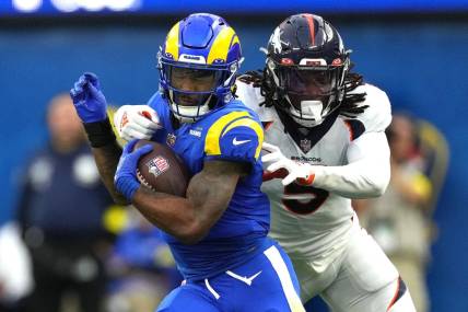 Dec 25, 2022; Inglewood, California, USA; Los Angeles Rams running back Cam Akers (3) carries the ball against Denver Broncos linebacker Randy Gregory (5) in the first half at SoFi Stadium. Mandatory Credit: Kirby Lee-USA TODAY Sports