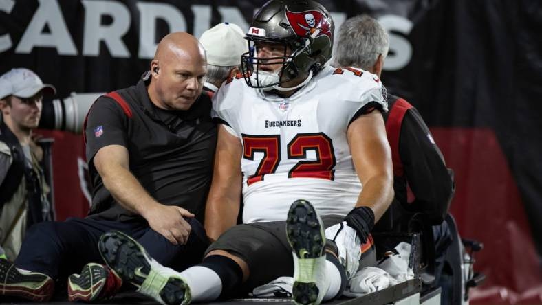 Dec 25, 2022; Glendale, Arizona, USA; Tampa Bay Buccaneers offensive tackle Josh Wells (72) is taken to the locker room on a cart after suffering an injury against the Arizona Cardinals at State Farm Stadium. Mandatory Credit: Mark J. Rebilas-USA TODAY Sports