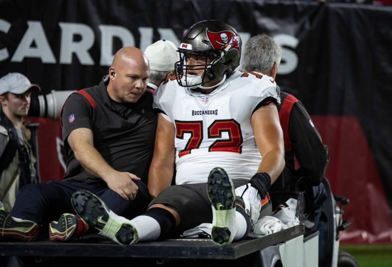 Dec 25, 2022; Glendale, Arizona, USA; Tampa Bay Buccaneers offensive tackle Josh Wells (72) is taken to the locker room on a cart after suffering an injury against the Arizona Cardinals at State Farm Stadium. Mandatory Credit: Mark J. Rebilas-USA TODAY Sports