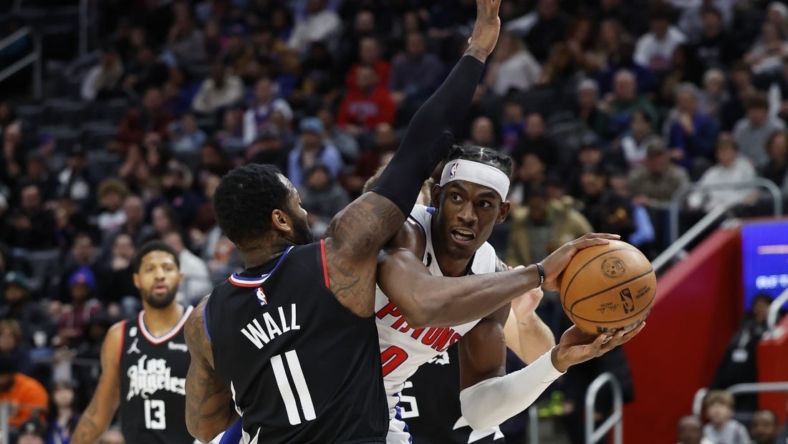 Dec 26, 2022; Detroit, Michigan, USA;  Detroit Pistons center Jalen Duren (0) is defended by LA Clippers guard John Wall (11) in the first half at Little Caesars Arena. Mandatory Credit: Rick Osentoski-USA TODAY Sports