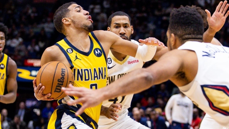 Dec 26, 2022; New Orleans, Louisiana,  USA;  Indiana Pacers guard Tyrese Haliburton (0) drives to the basket against New Orleans Pelicans forward Garrett Temple (41) and guard CJ McCollum (3) during the first half at Smoothie King Center. Mandatory Credit: Stephen Lew-USA TODAY Sports