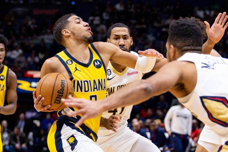 Dec 26, 2022; New Orleans, Louisiana,  USA;  Indiana Pacers guard Tyrese Haliburton (0) drives to the basket against New Orleans Pelicans forward Garrett Temple (41) and guard CJ McCollum (3) during the first half at Smoothie King Center. Mandatory Credit: Stephen Lew-USA TODAY Sports