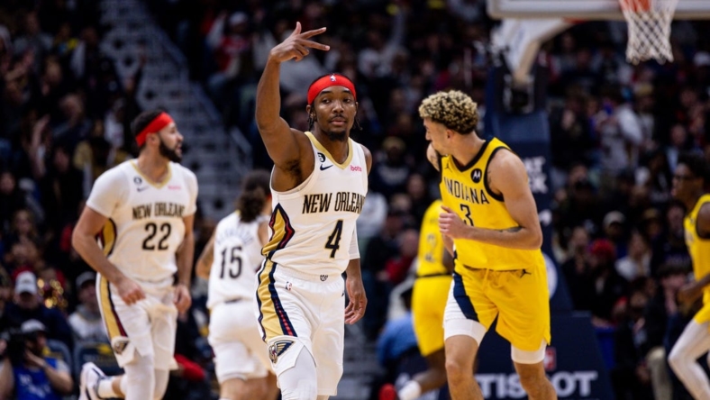Dec 26, 2022; New Orleans, Louisiana,  USA;  New Orleans Pelicans guard Devonte' Graham (4) reacts to making a three point basket against Indiana Pacers guard Chris Duarte (3) during the first half at Smoothie King Center. Mandatory Credit: Stephen Lew-USA TODAY Sports