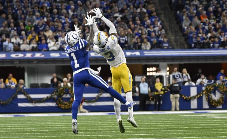 Dec 26, 2022; Indianapolis, Indiana, USA;  Los Angeles Chargers safety Derwin James Jr. (3) intercepts a pass meant for Indianapolis Colts wide receiver Parris Campbell (1) during the first quarter at Lucas Oil Stadium. Mandatory Credit: Marc Lebryk-USA TODAY Sports